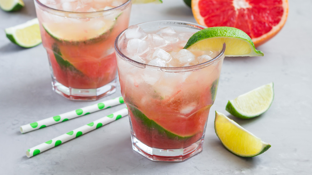 Two paloma cocktails with lime