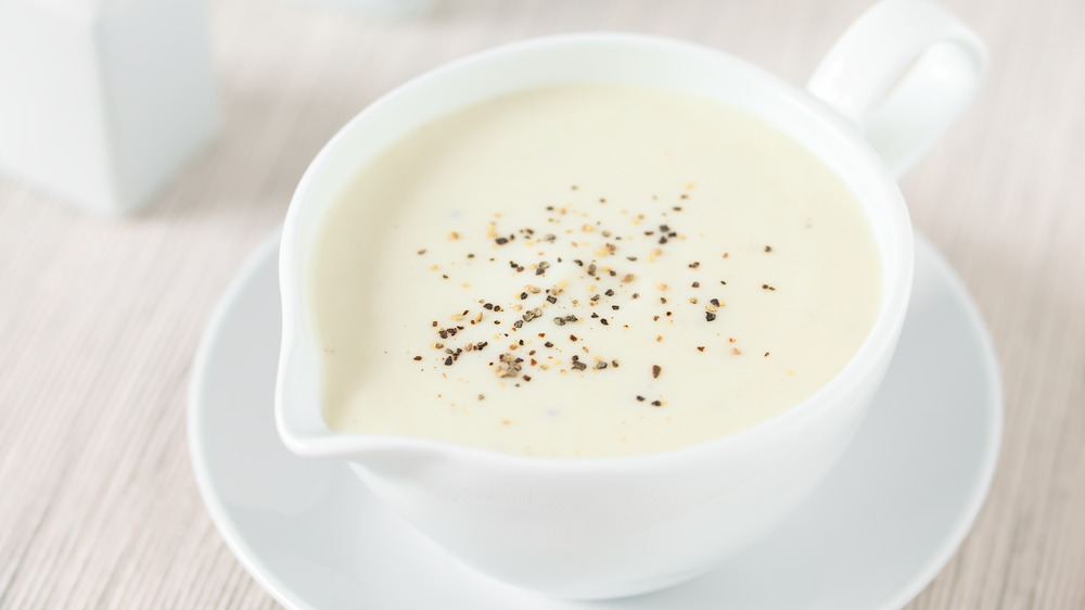 Béchamel sauce in a white bowl.