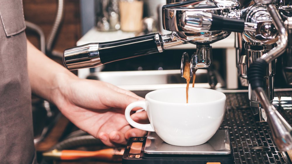 barista using an espresso machine