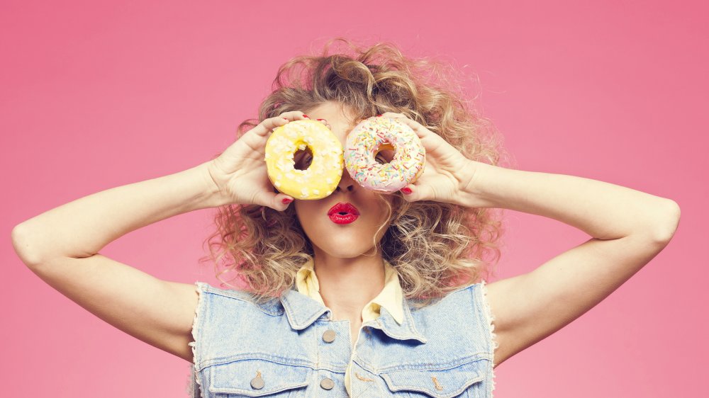 Woman holding donuts