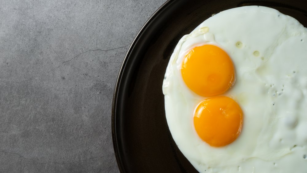 Two sunny side up eggs in a skillet