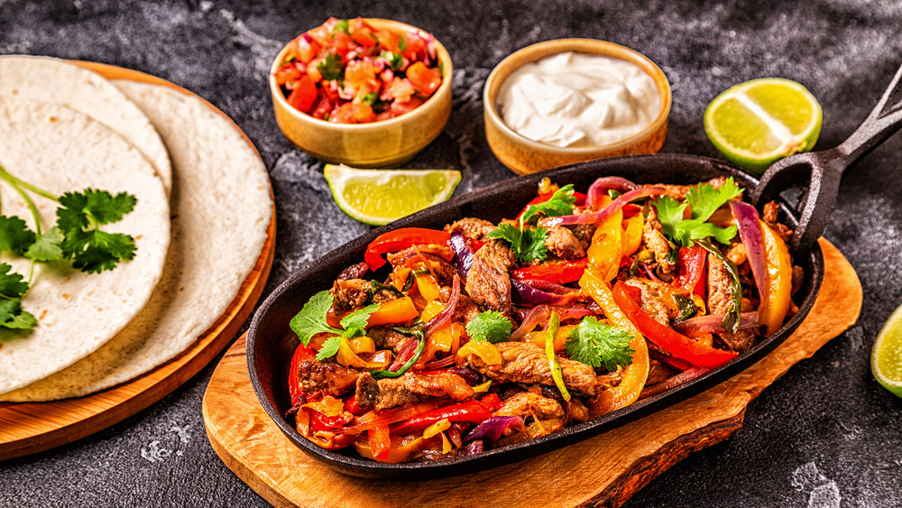 fajita meat with toppings and tortillas