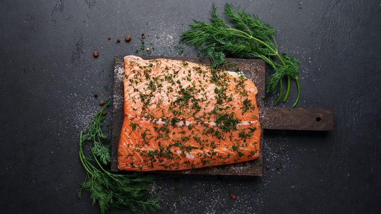 filet of gravlax on wooden board