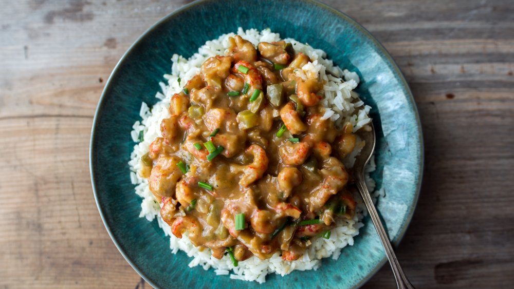 crawfish etouffee served over rice in a blue bowl