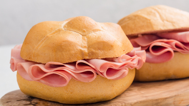 Mortadella sandwiches atop wooden board