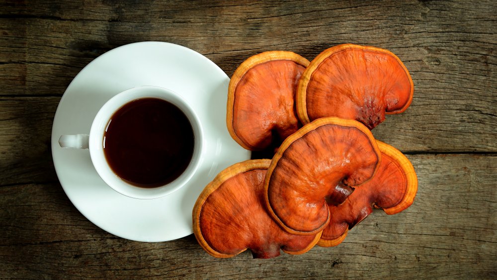 Cup of mushroom coffee beside whole mushrooms