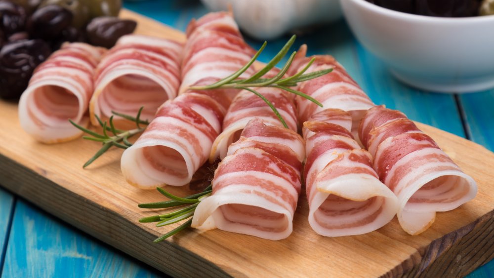 Pancetta slices on a cutting board