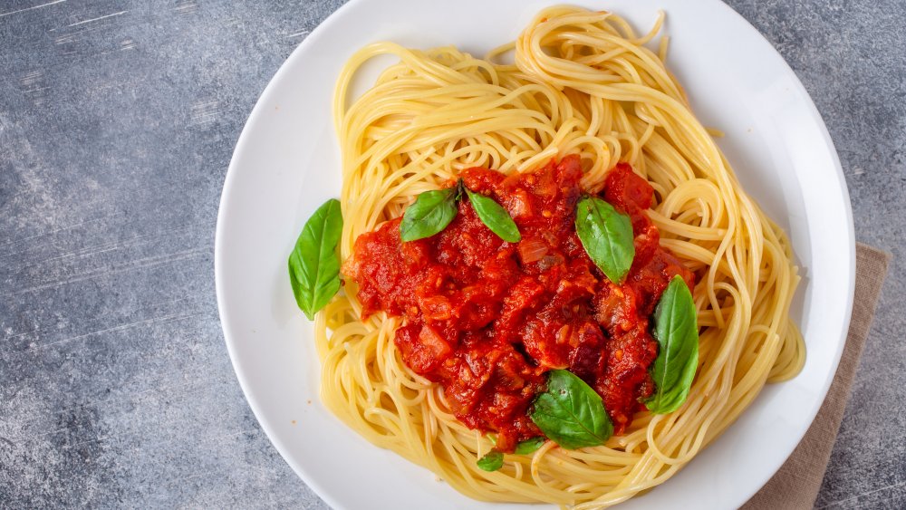 Plate of spaghetti with pomodoro sauce and basil