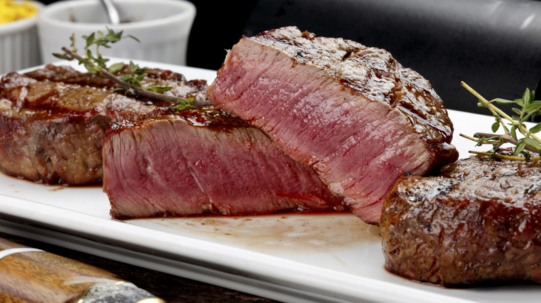 Rare steak cut open on a white plate