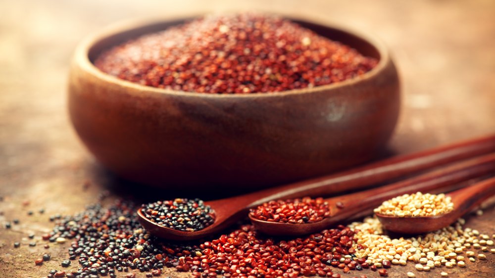 bowl of red quinoa with spoonfuls of red, black, and white quinoa