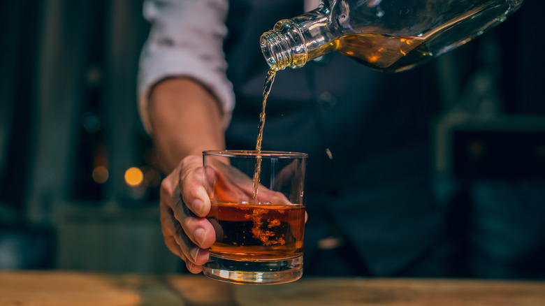 Bartender pouring whisky