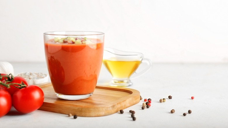 A glass of cold gazpacho over a wooden table