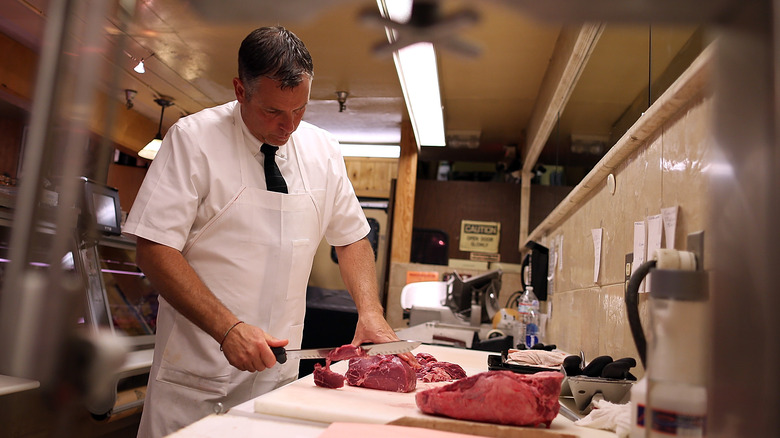 butcher cutting beef