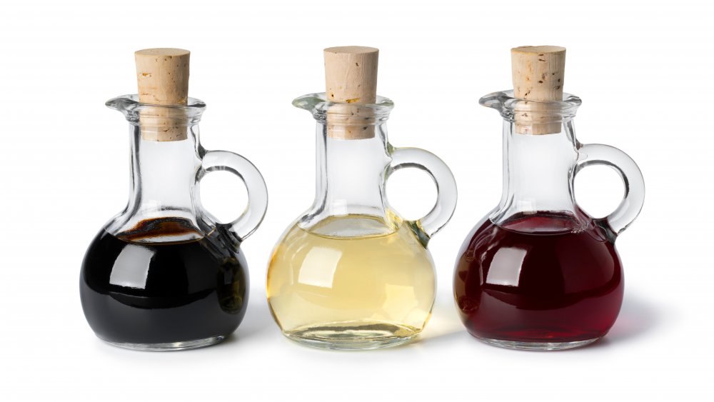 bottles of vinegar on white background