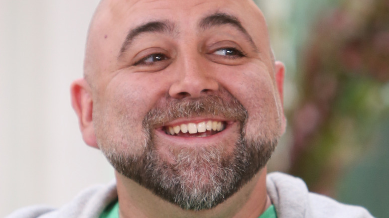 Duff Goldman smiles in hoodie and green shirt