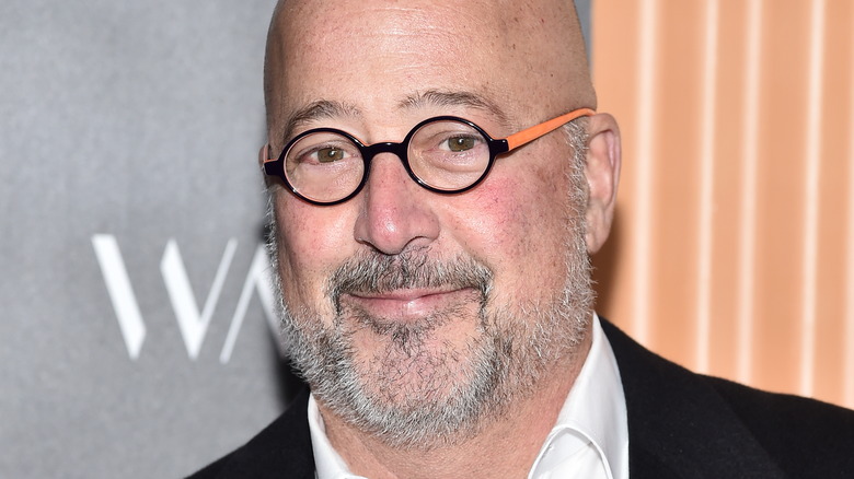 Andrew Zimmern smiling slightly