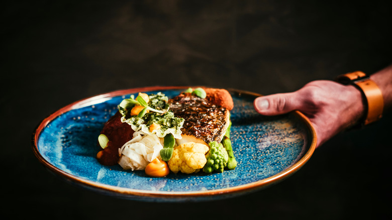 Person serving plate of food