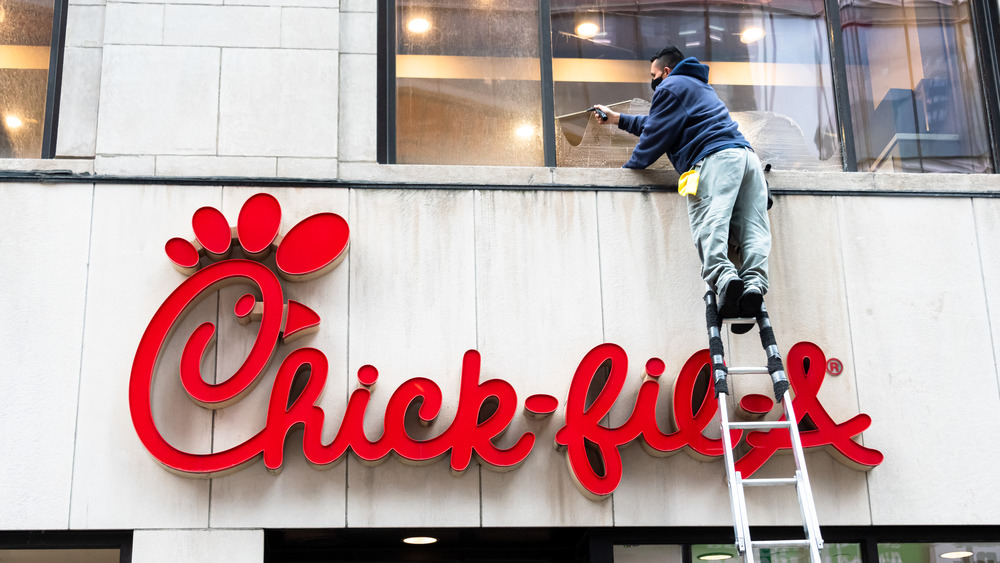 Worker on ladder at Chick-fil-A