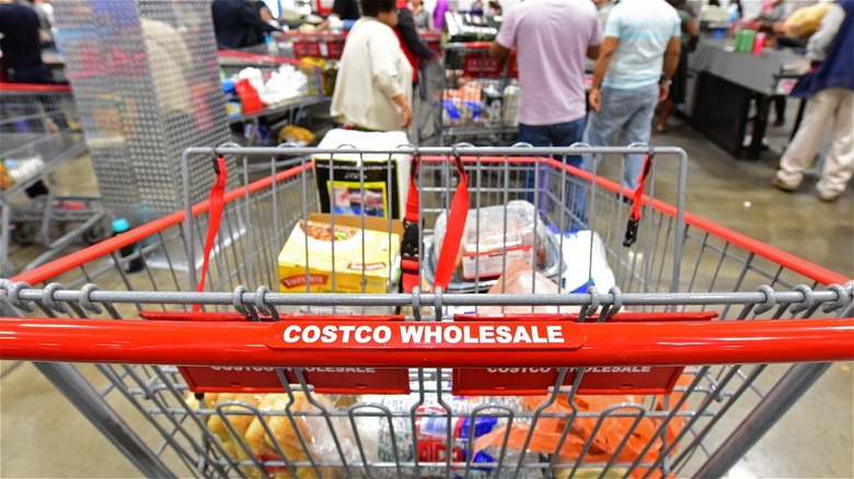 Costco cart filled with food in checkout aisle