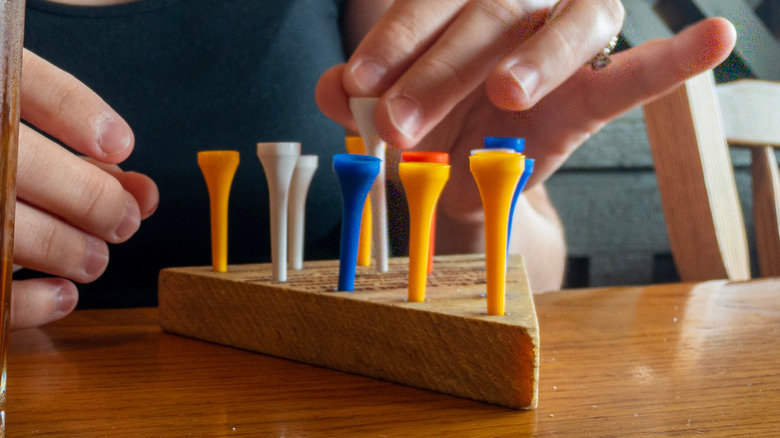 Person playing Cracker Barrel game