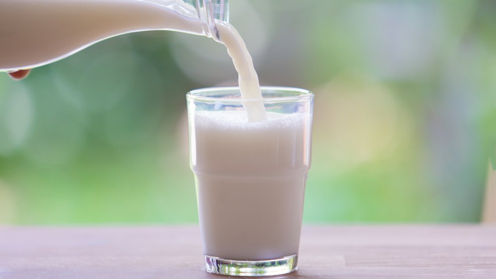 Milk being poured form a jug into a glass