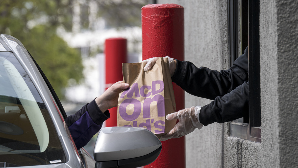 Handing fast food in a drive thru