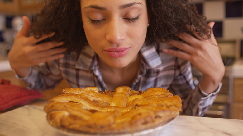 woman smelling apple pie