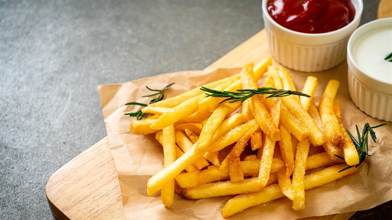 French fries with rosemary and condiments 