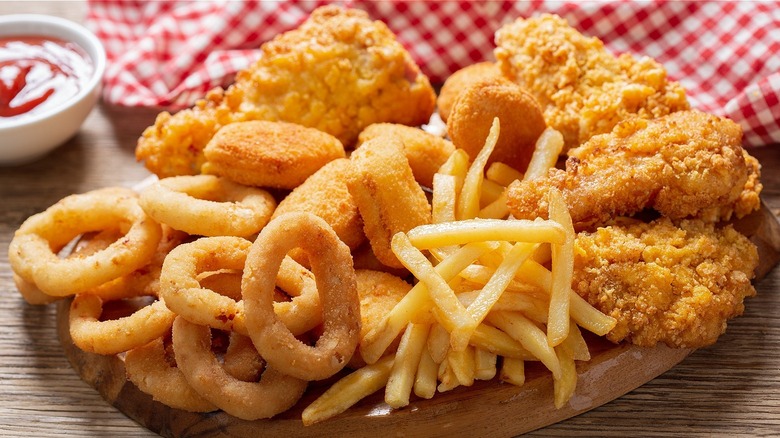 basket of onion rings, french fries, and chicken tenders