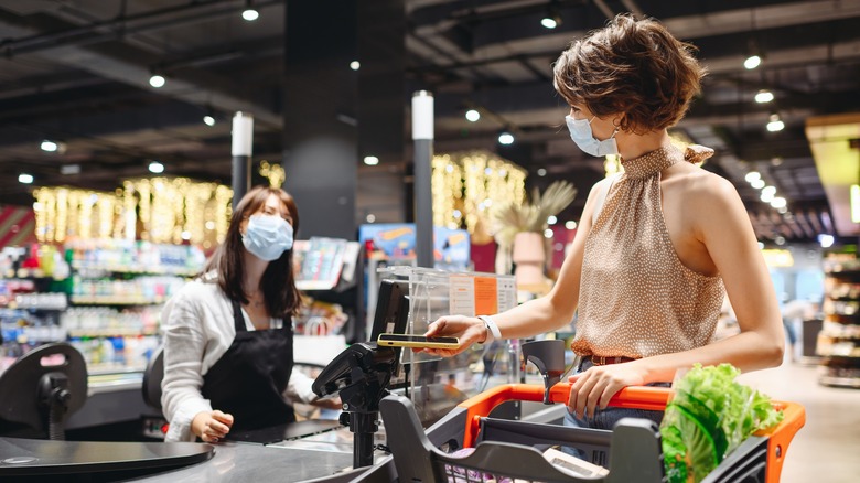 Woman at grocery store checkout