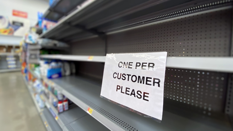 empty shelf with sign limiting amount of item customers can buy