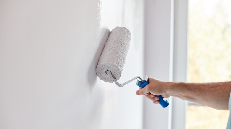 Rolling paint on wall