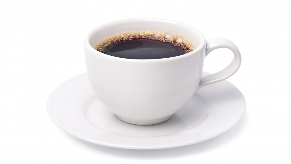 Black coffee in a white cup against a white background.