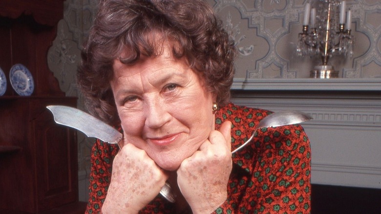 Julia Child holding spoon and knife
