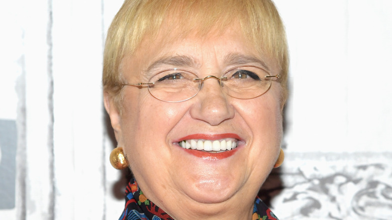 Lidia Bastianich smiles with glasses and red lipstick