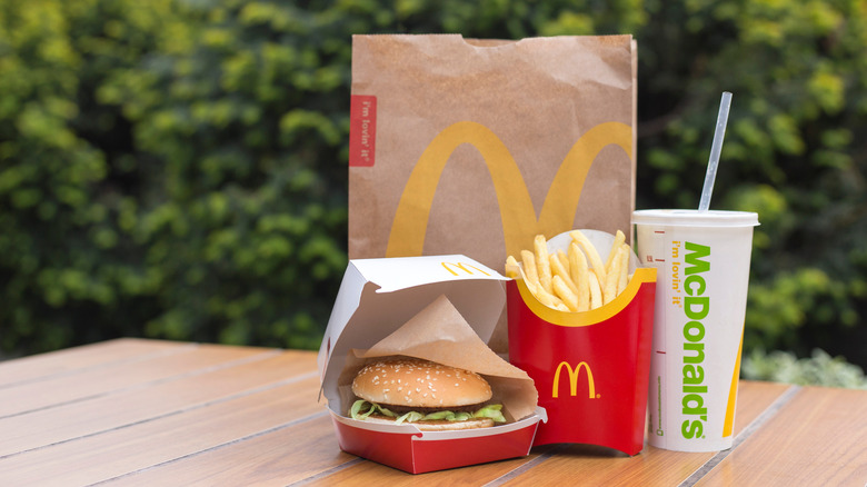 McDonalds bag and food on a table. 