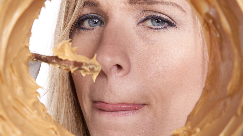 Person looking into peanut butter jar