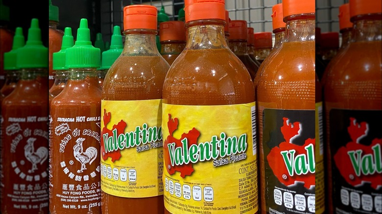 Bottles of Valentina hot sauce on store shelf