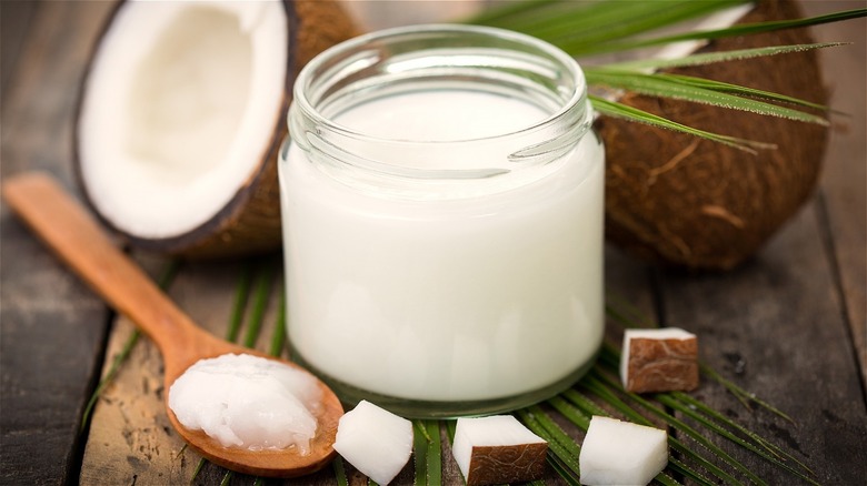 Coconut milk in jar with wooden spoon