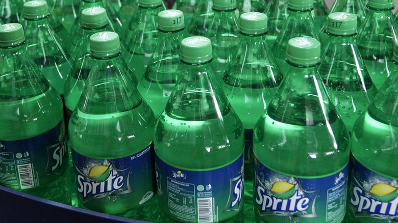 Customer grabbing Sprite bottle from shelf