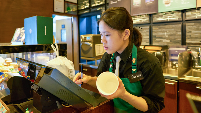 Starbucks employee at cash register