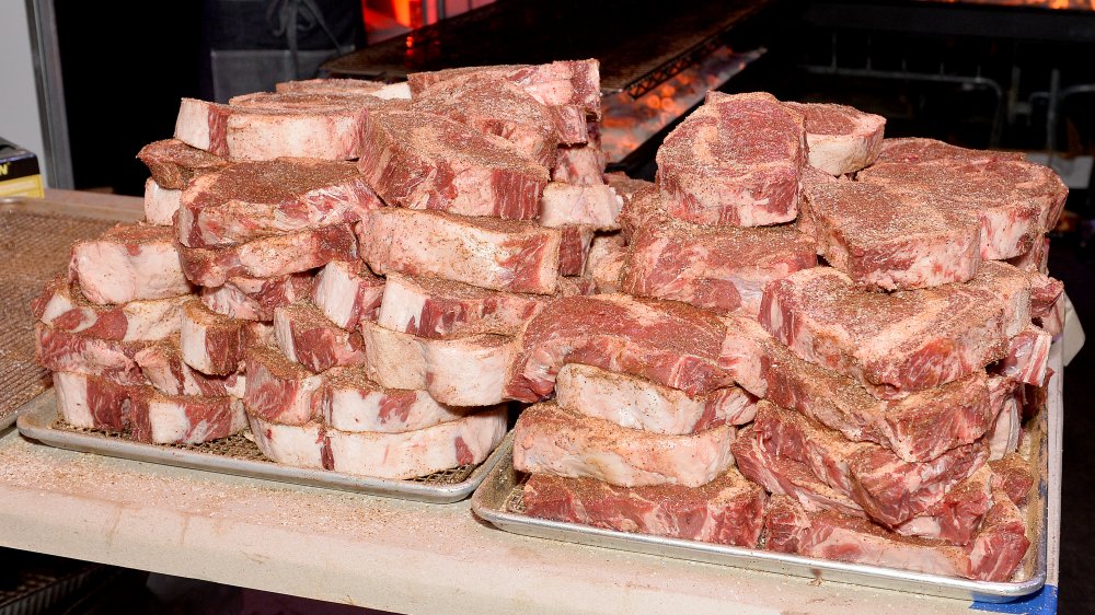 A pile of uncooked steaks looking oh so appetizing. 