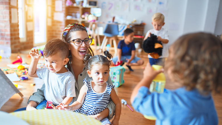 Childcare worker playing with kids