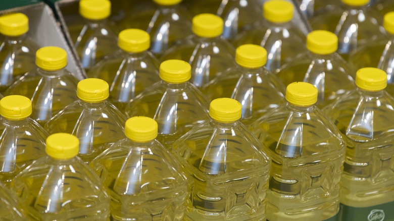 Display of vegetable oil jugs with yellow caps