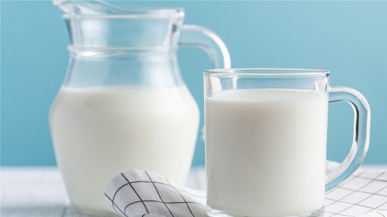 White milk in pitcher and jar