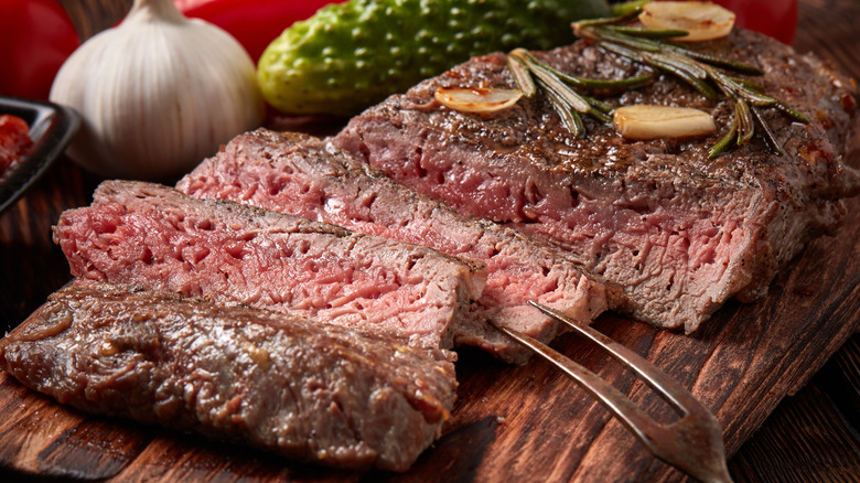 cooked steak with garlic and rosemary