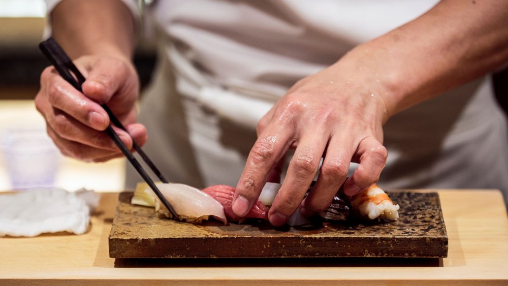 Male chef preparing sushi platter