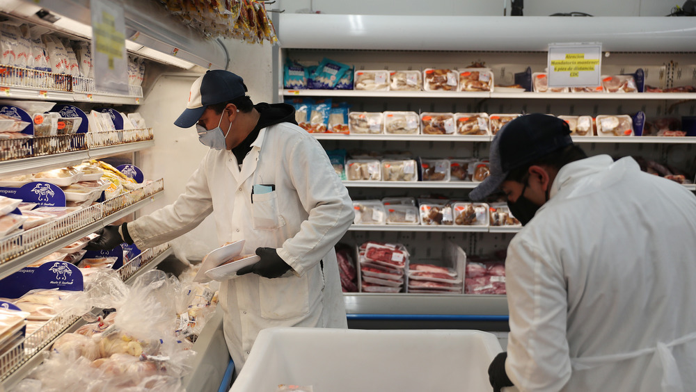 Workers restocking fresh food