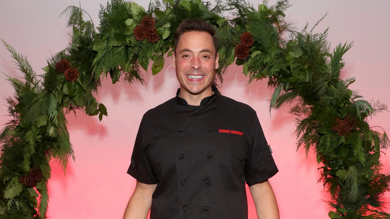 Holiday Wars host Jeff Mauro with a large wreath