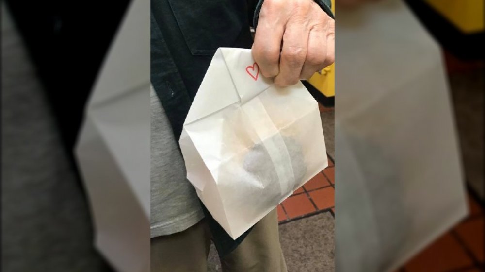 donut in white bag with heart drawn in red